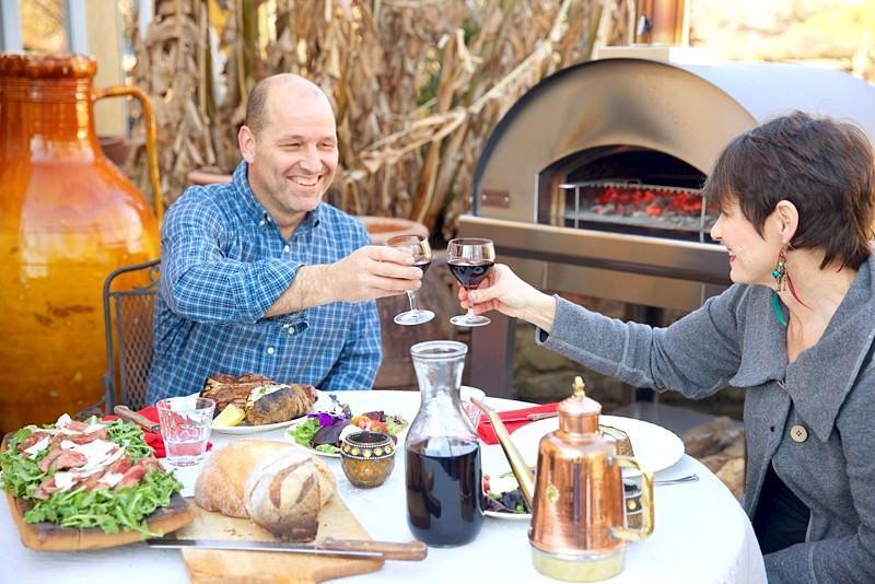 adults drinking wine at table