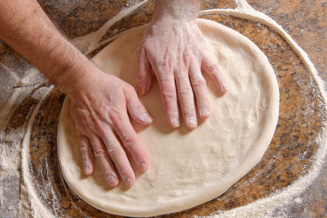 chef preparing pizza dough