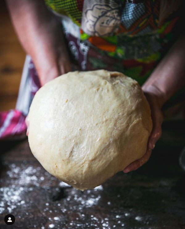 Hands of chef with dough in kitchen