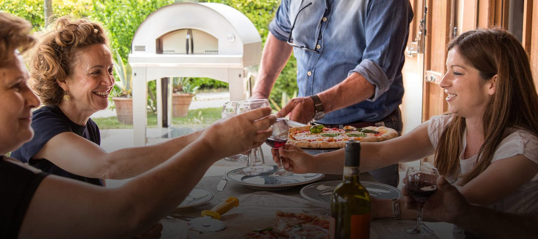 Happy family enjoying red wine and eating pizza on outdoor