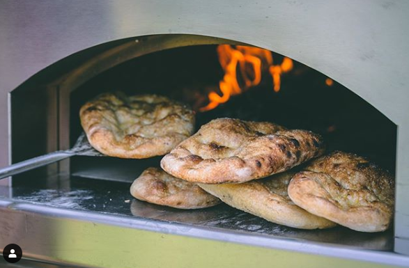 making naan in wood fired oven