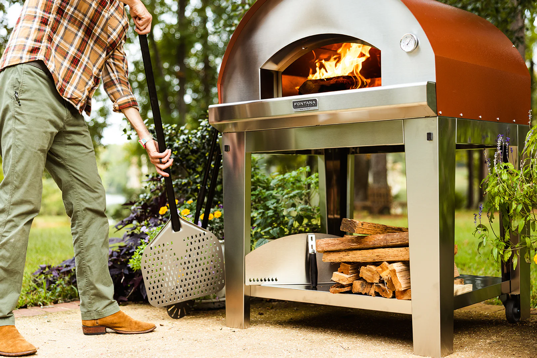 Man fueling a wood fired pizza oven from Fontana Forni