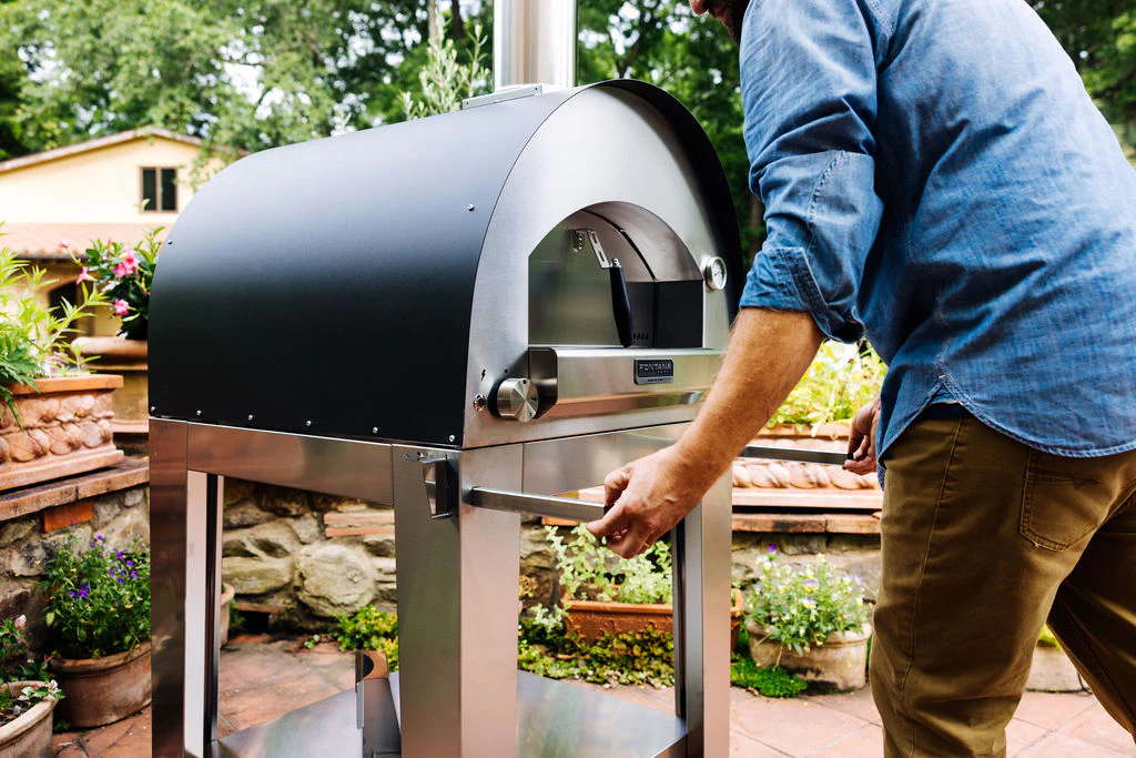 Man using his new hybrid pizza oven from Fontana Forni