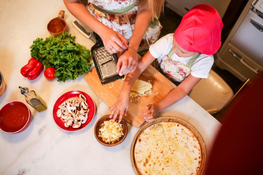 Mother and daughter in the kitchen making pizza