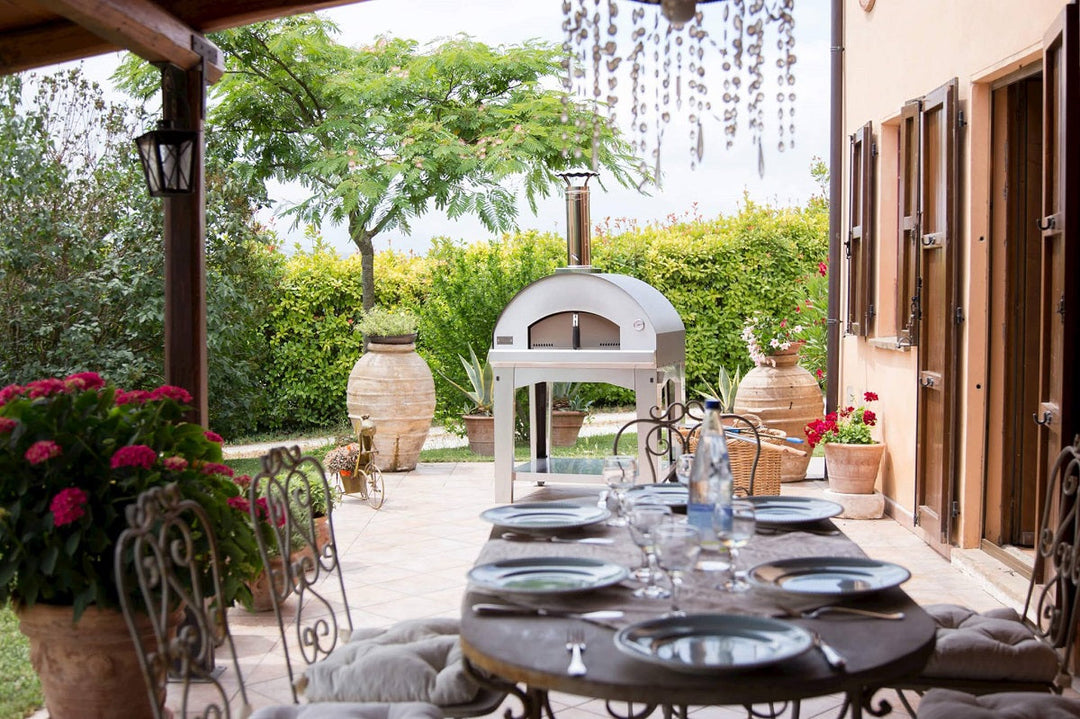 Outdoor pizza oven with dining table at backyard garden