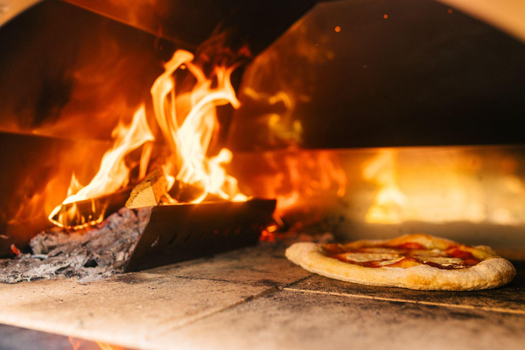 Pizza cooking on a pizza stone
