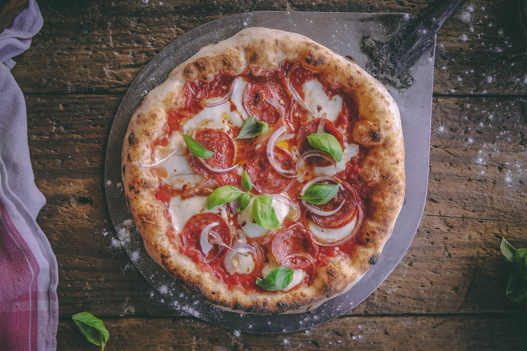 pizza with mozzarella and basil leaves