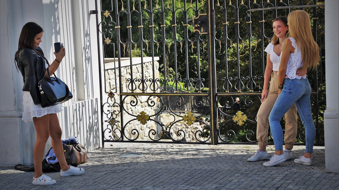 three young happy teens taking selfie photos on smartphone