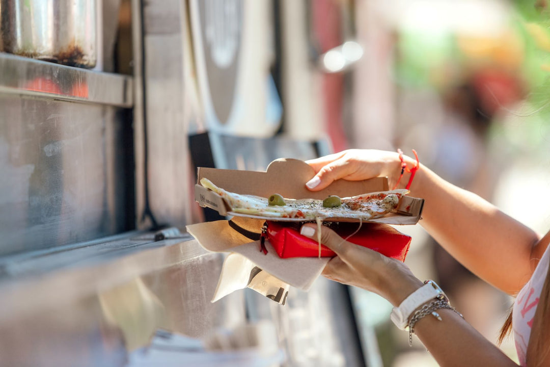 Woman Buying Pizza From A Food Truck