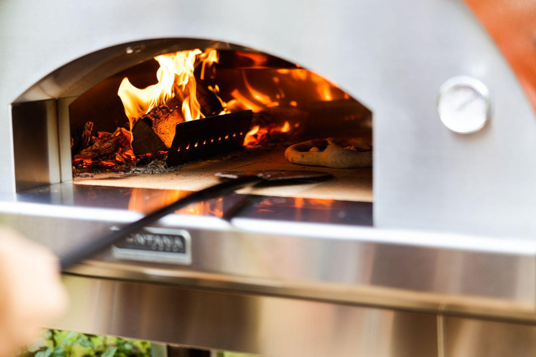 Wood cooking a pizza in a wood fired pizza oven from Fontana Forni