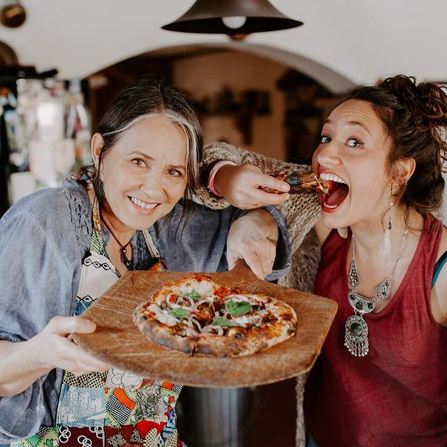 young women enjoying pizza meal