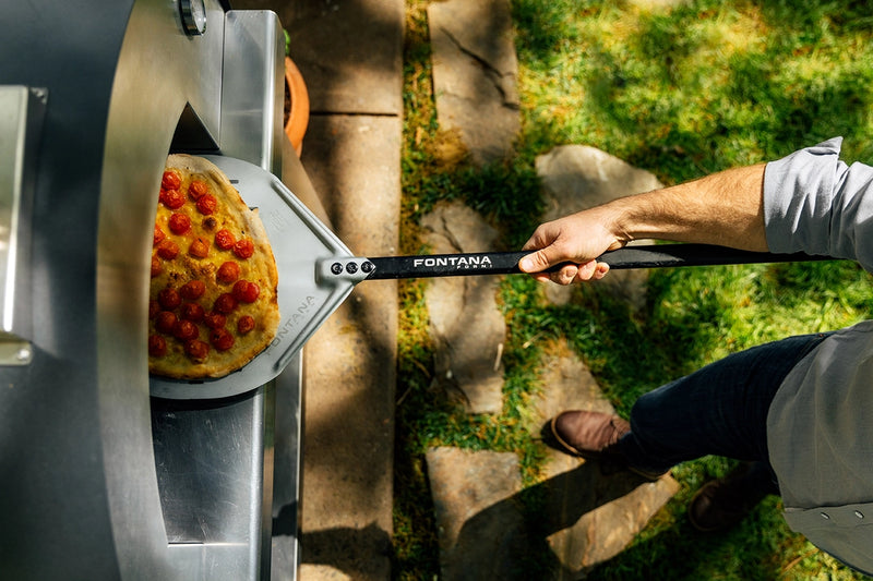 Pizza Coming Out of a Margherita Wood-Fired Oven 