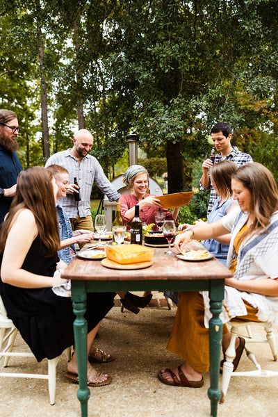 People Sitting Around a Table Enjoying a Margherita Wood-Fired Oven #color_gray