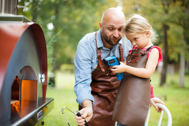 Man and Girl Playing With an Infrared Thermometer 