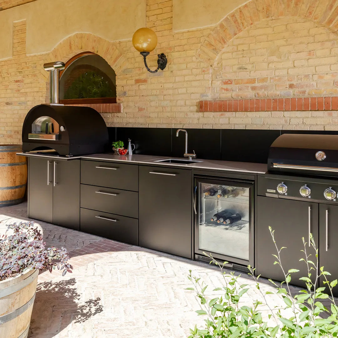 Elysia Outdoor Kitchen configuration on patio against a tan brick wall