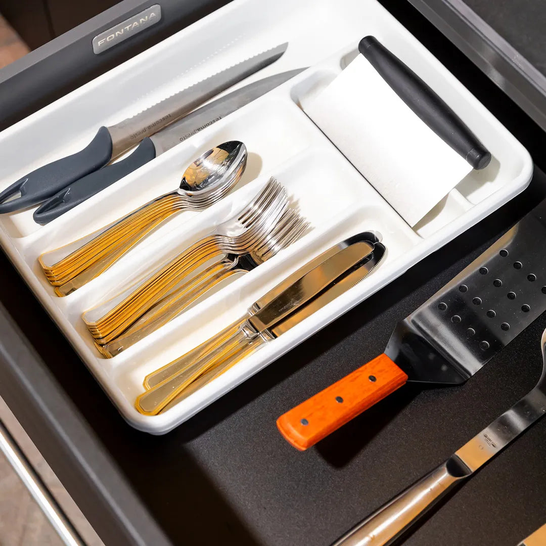 Open drawer of Elysia module with white tray holding cutlery and utensils with Fontana name plate inside drawer