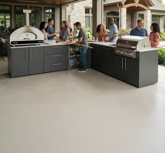 Elysia Outdoor kitchen with people socializing, featuring a pizza oven and grill