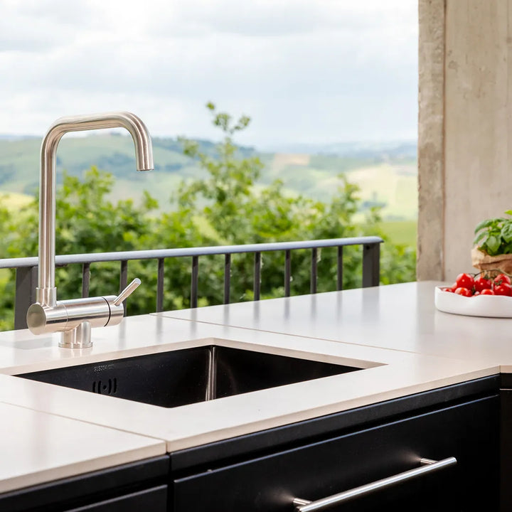 Silver singk faucet and under-mount sink in light colored countertop of Elysia   Sink Module
