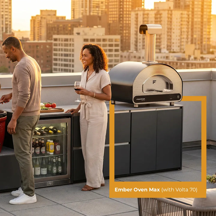 Two people on a rooftop with an Ember Oven Max and Volta 70, cityscape in the background.