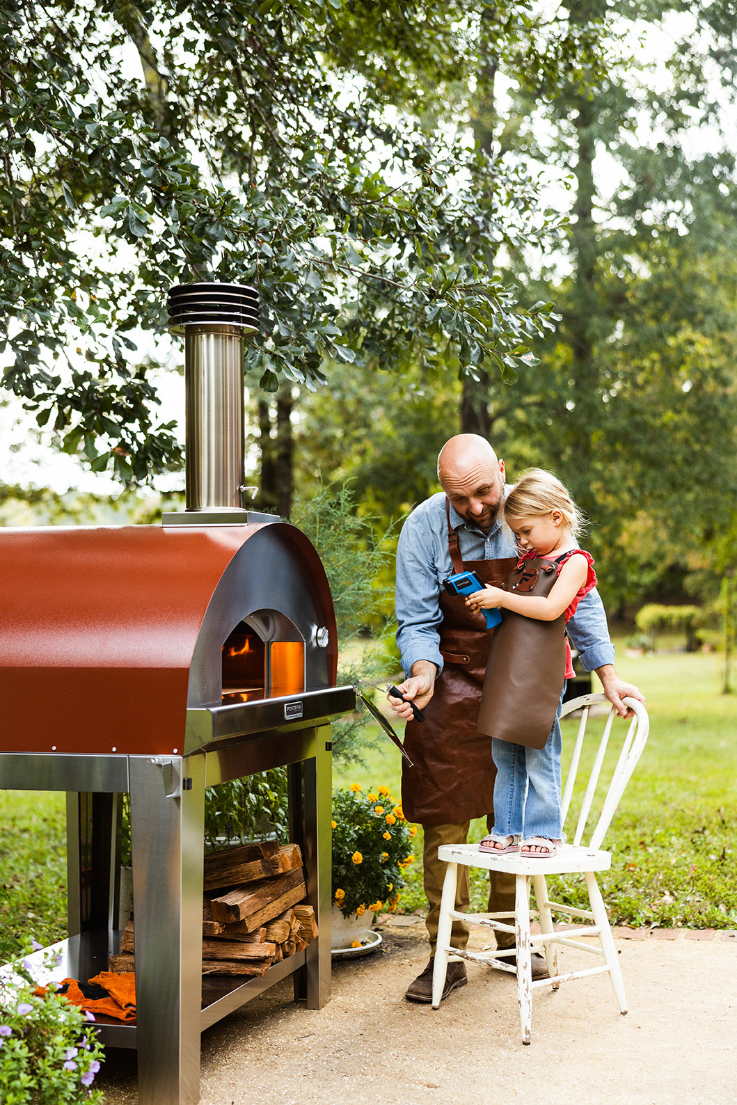 Little Girl and Father Using an Infrared Thermometer on a Pizza Oven
