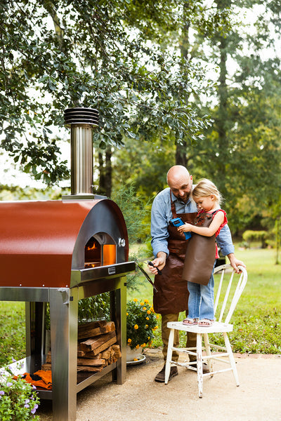 Little Girl and Father Using an Infrared Thermometer on a Pizza Oven