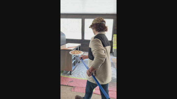 Person Putting in a Pizza in a Prometeo Commercial Wood-Fired Oven