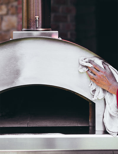 Person Using the Oven Cleaning Kit to Clean a Fontana Oven